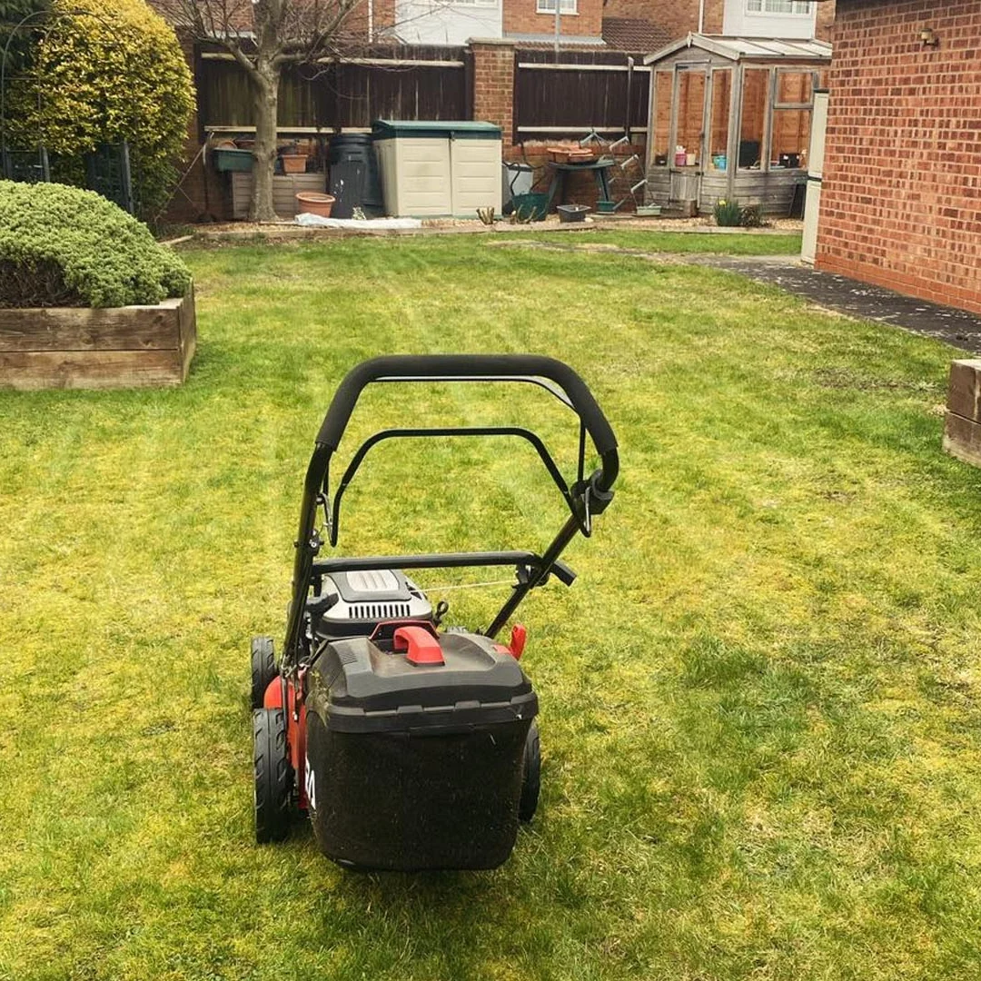 A lawn mower on a lawn freshly mown by Hortus Ground Care Limited